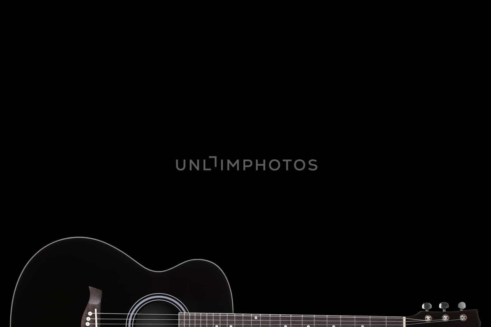 A black guitar on black background with copy space