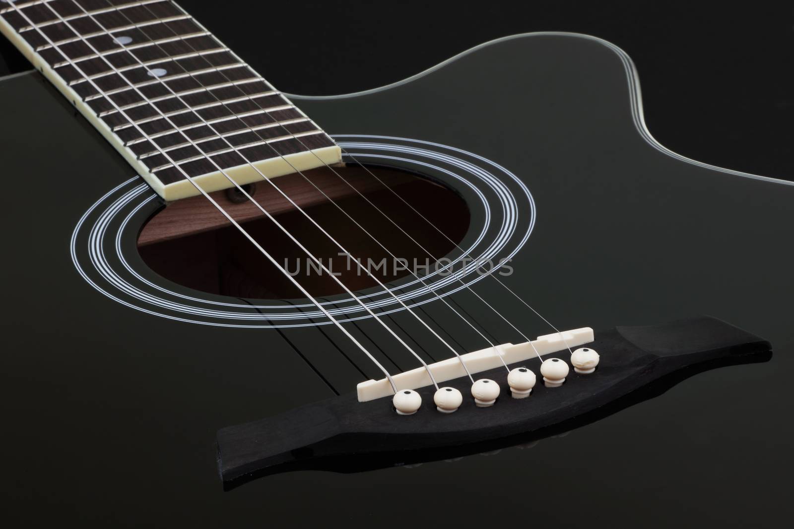 Body of black electric acoustic guitar on dark background by VivacityImages