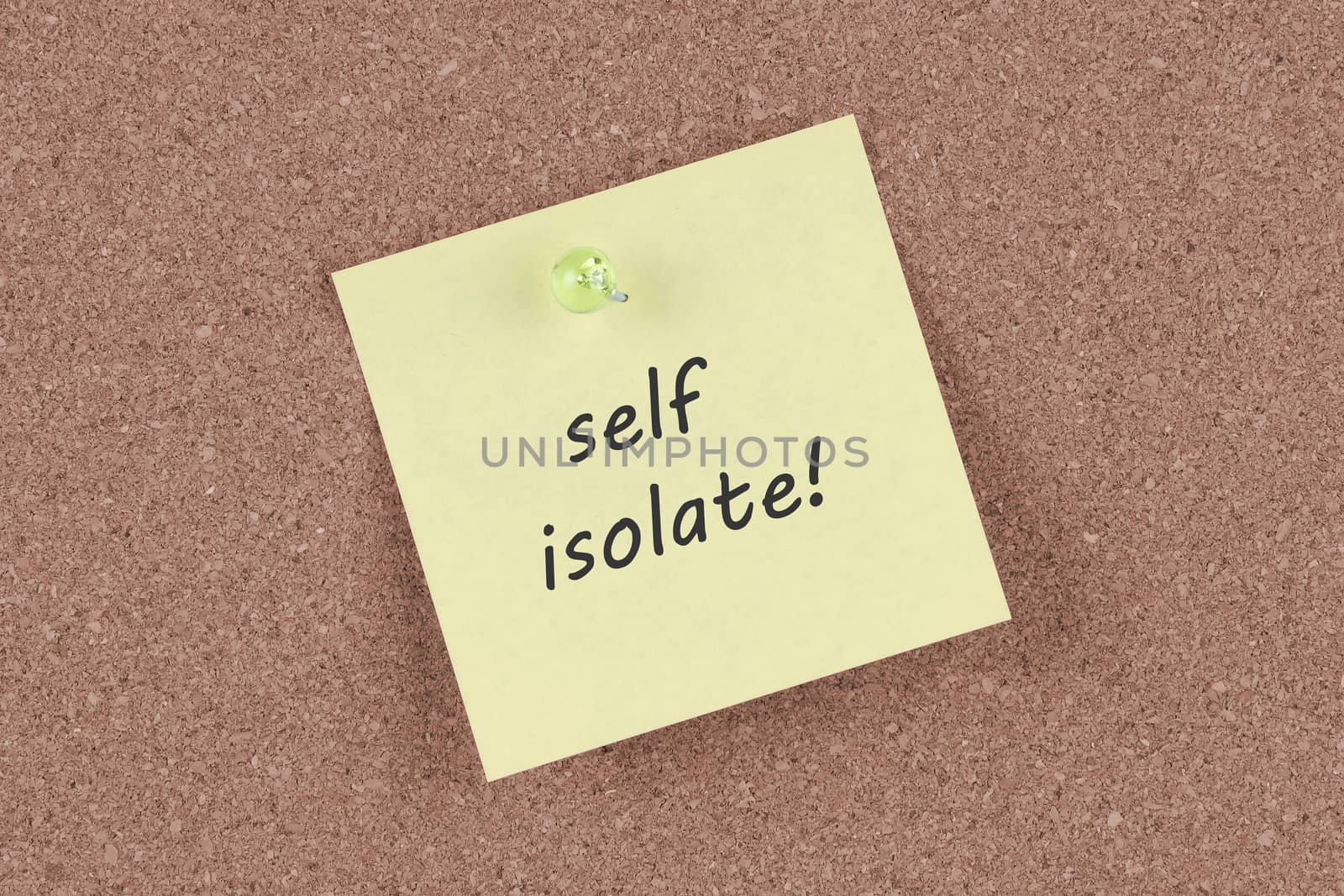 A self isolate post note on a cork notice board