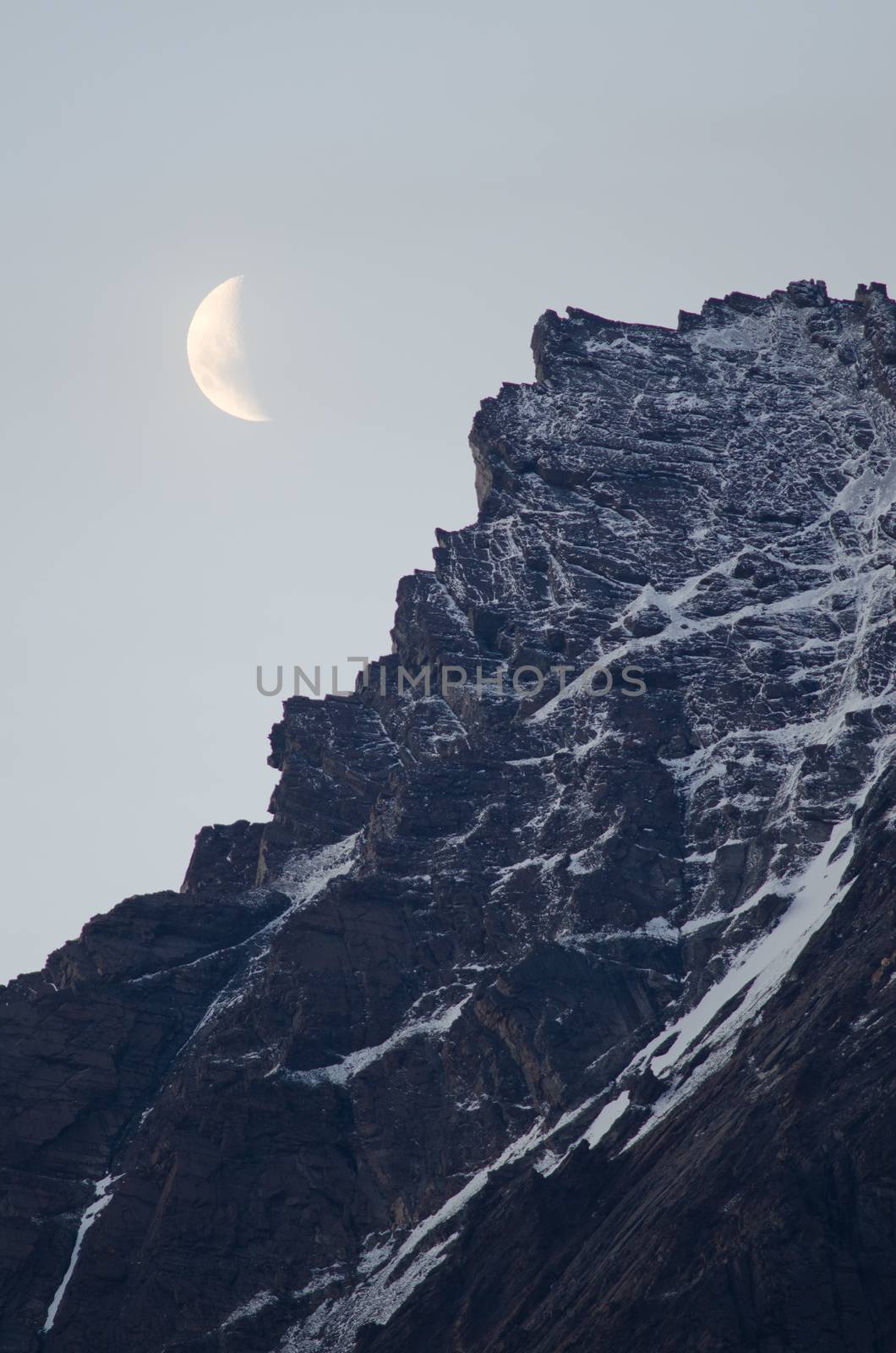 Moon on a cliff in the Torres del Paine National Park. Ultima Esperanza Province. Magallanes and Chilean Antarctic Region. Chile.