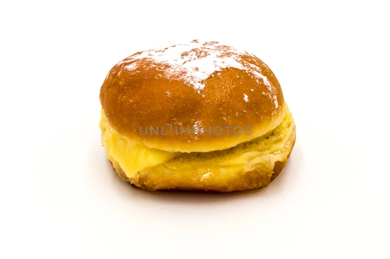 Bola de Berlim, or Berlim Ball, a Portuguese pastry made from a fried donut filled with sweet eggy cream and rolled in crunchy sugar on a white background.