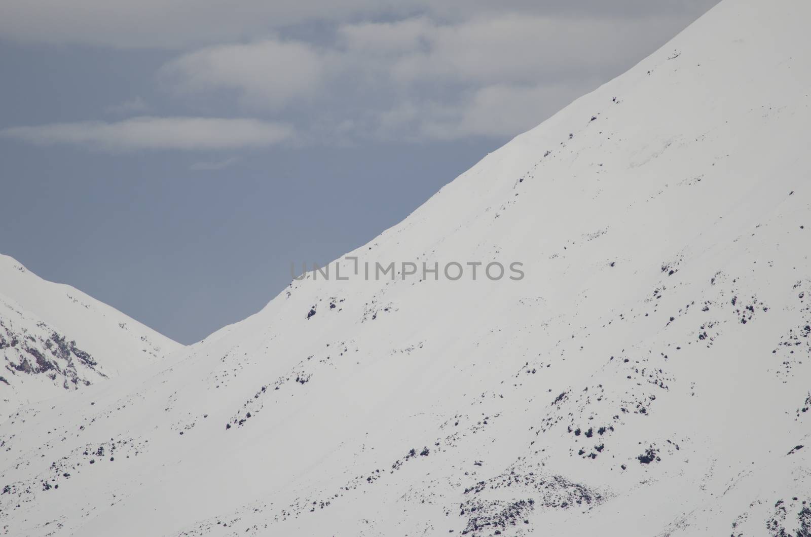 Snowy slopes of the Payachatas volcanic chain. Parinacota volcano hillside and back hillside Pomerape volcano. Lauca National Park. Arica y Parinacota Region. Chile.