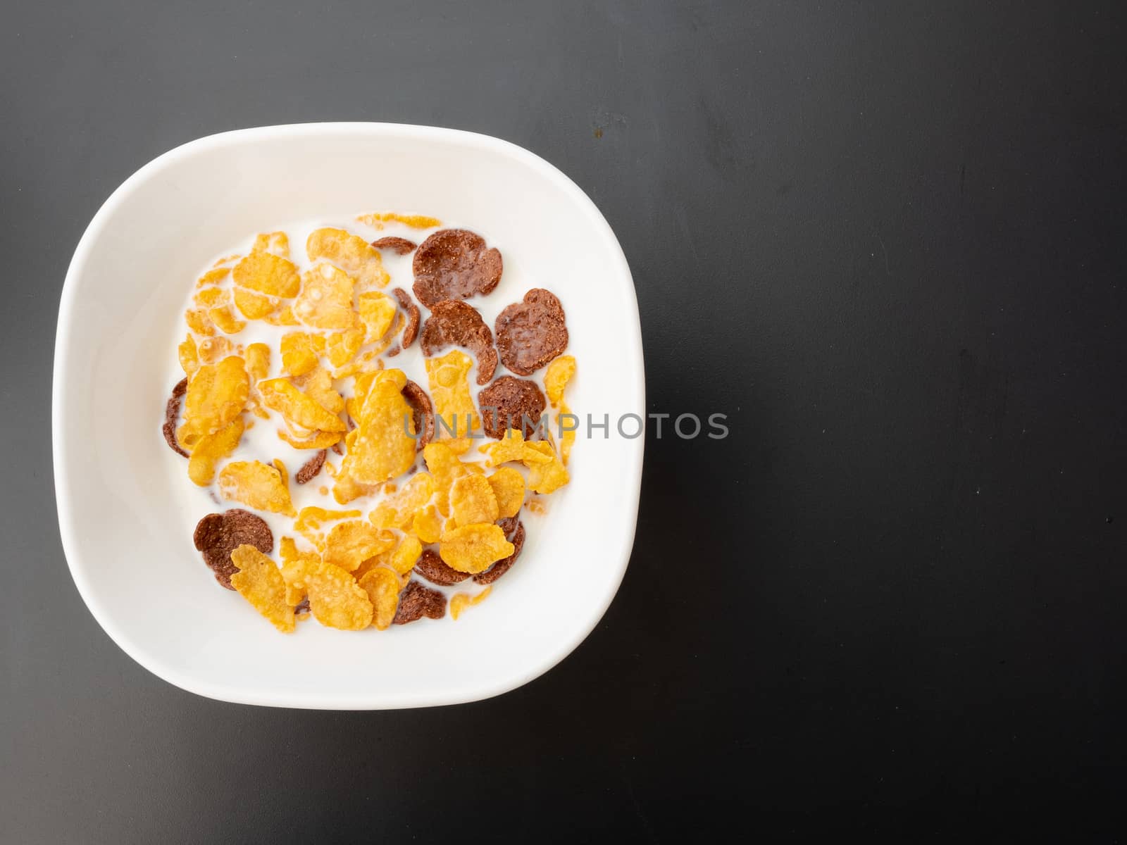 Breakfast is ready to be eaten in a white bowl consisting of cor by panyajampatong