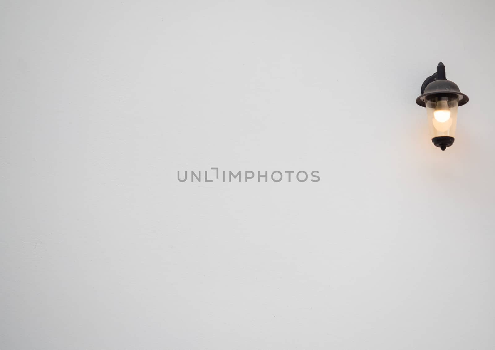 Warm light, led lamp in an antique lamp on a white wall in a minimalist style with copy space.