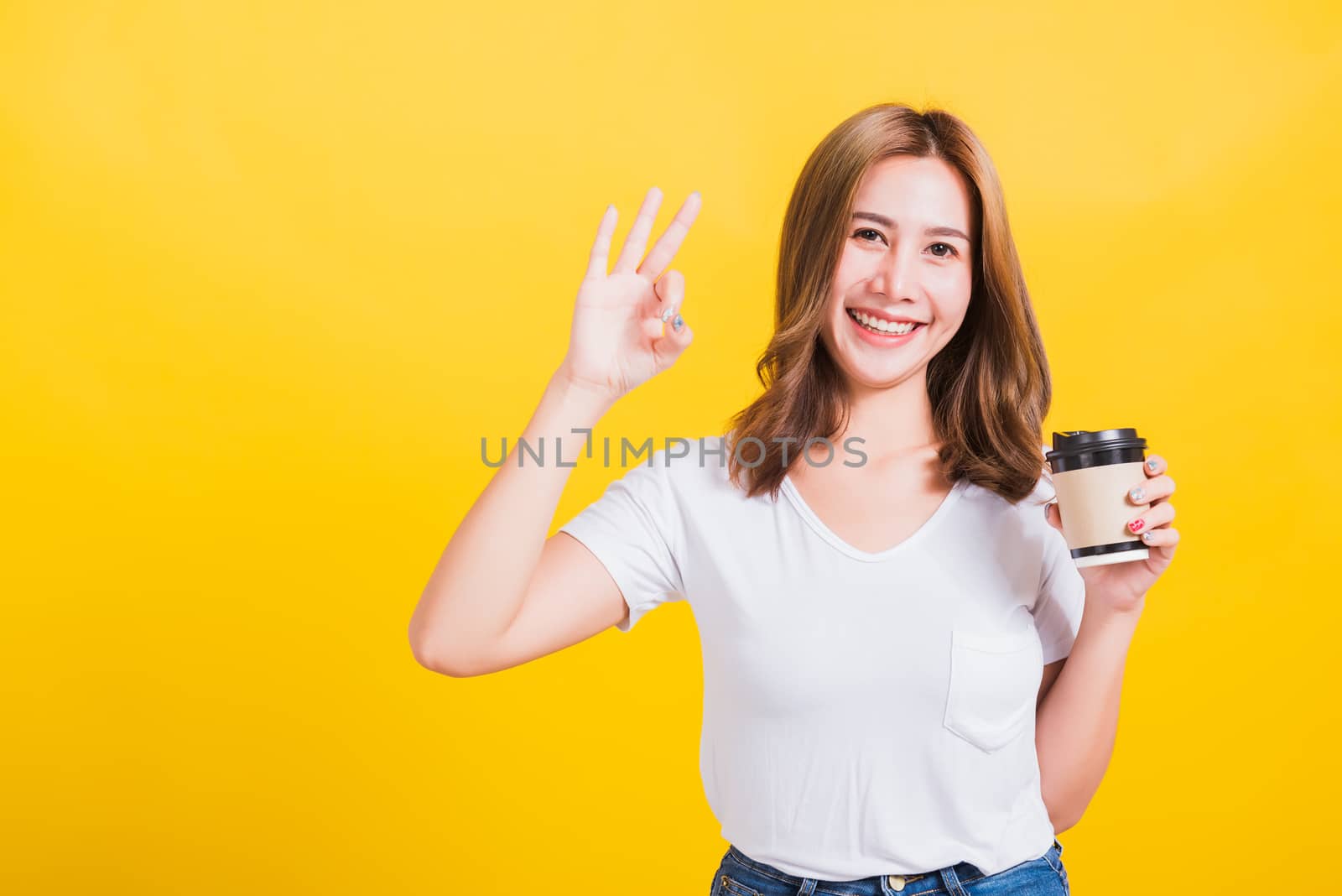 woman standing holds take away cup coffee paper and confident sh by Sorapop