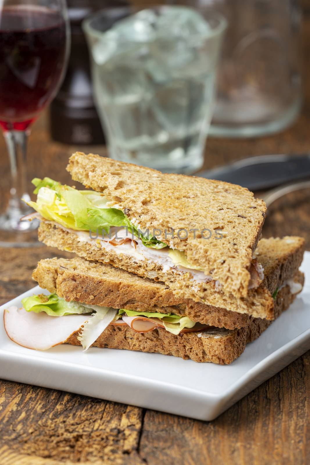 closeup of a ham sandwich on wood