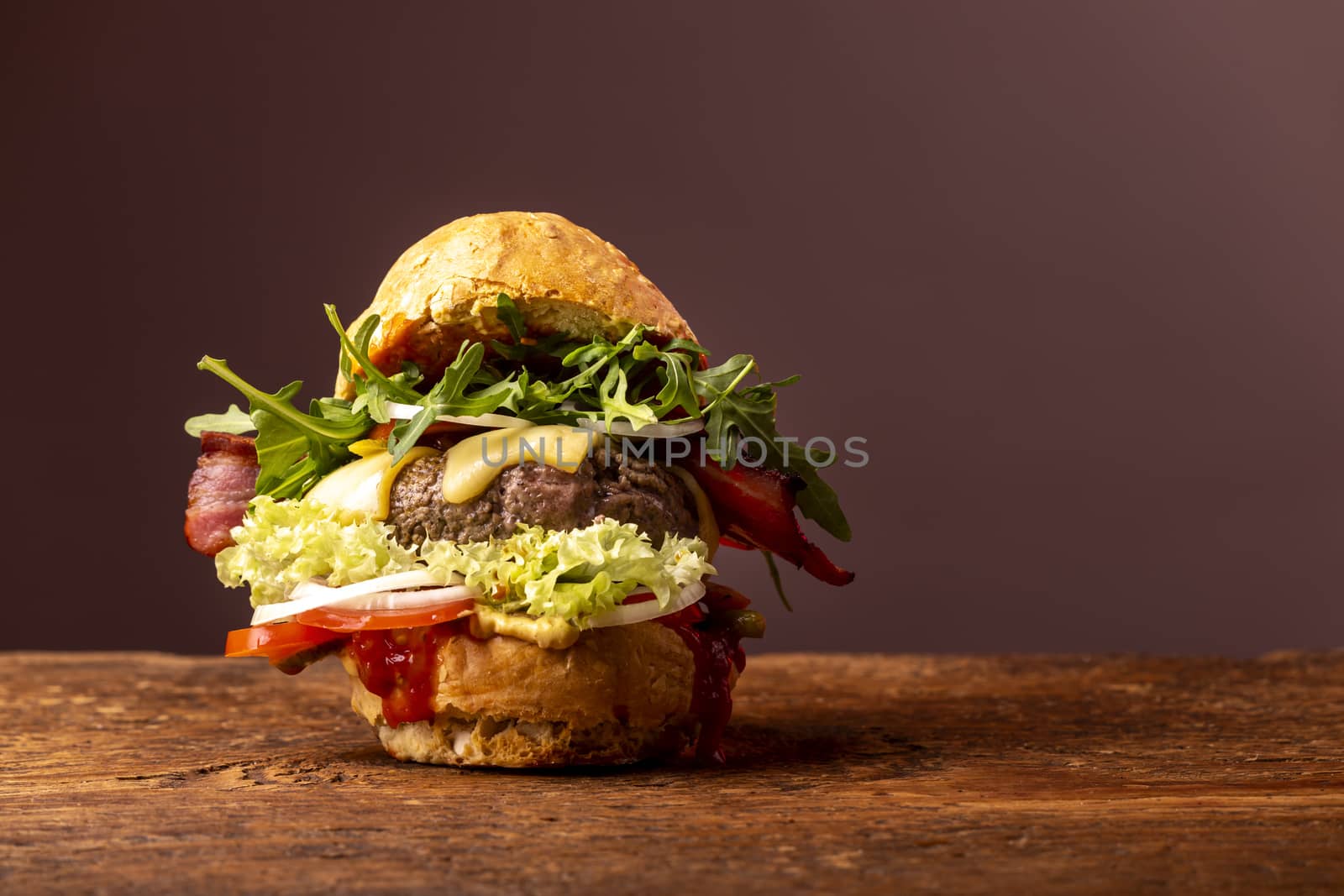 single hamburger on dark wood