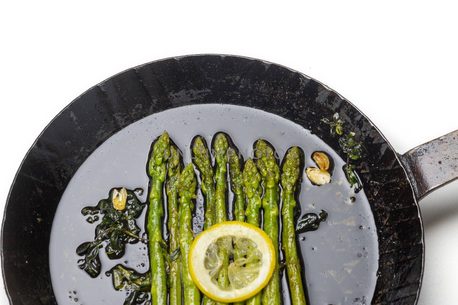 green asparagus in an iron pan