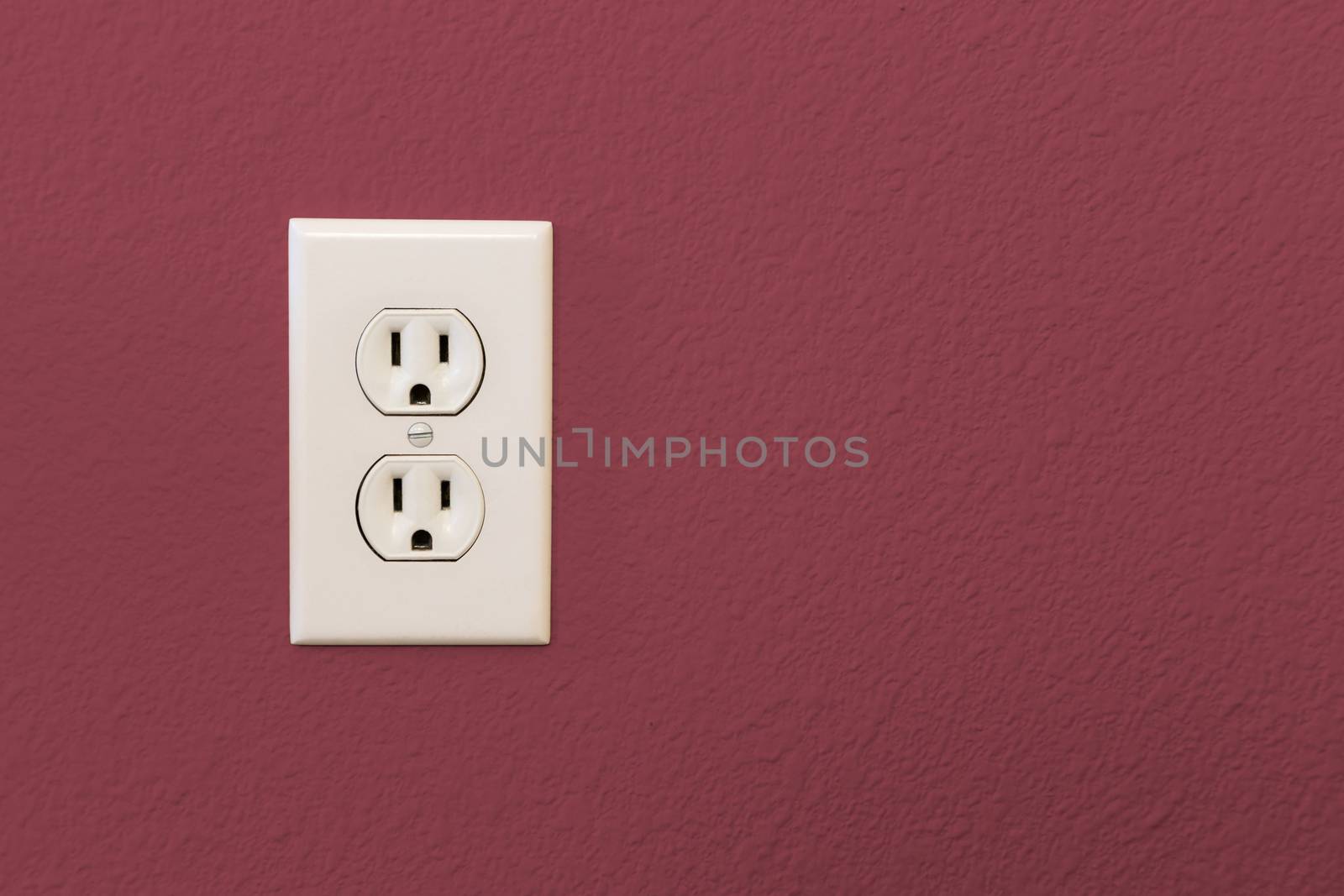 Electrical Sockets In Colorful Burgundy Wall of House.