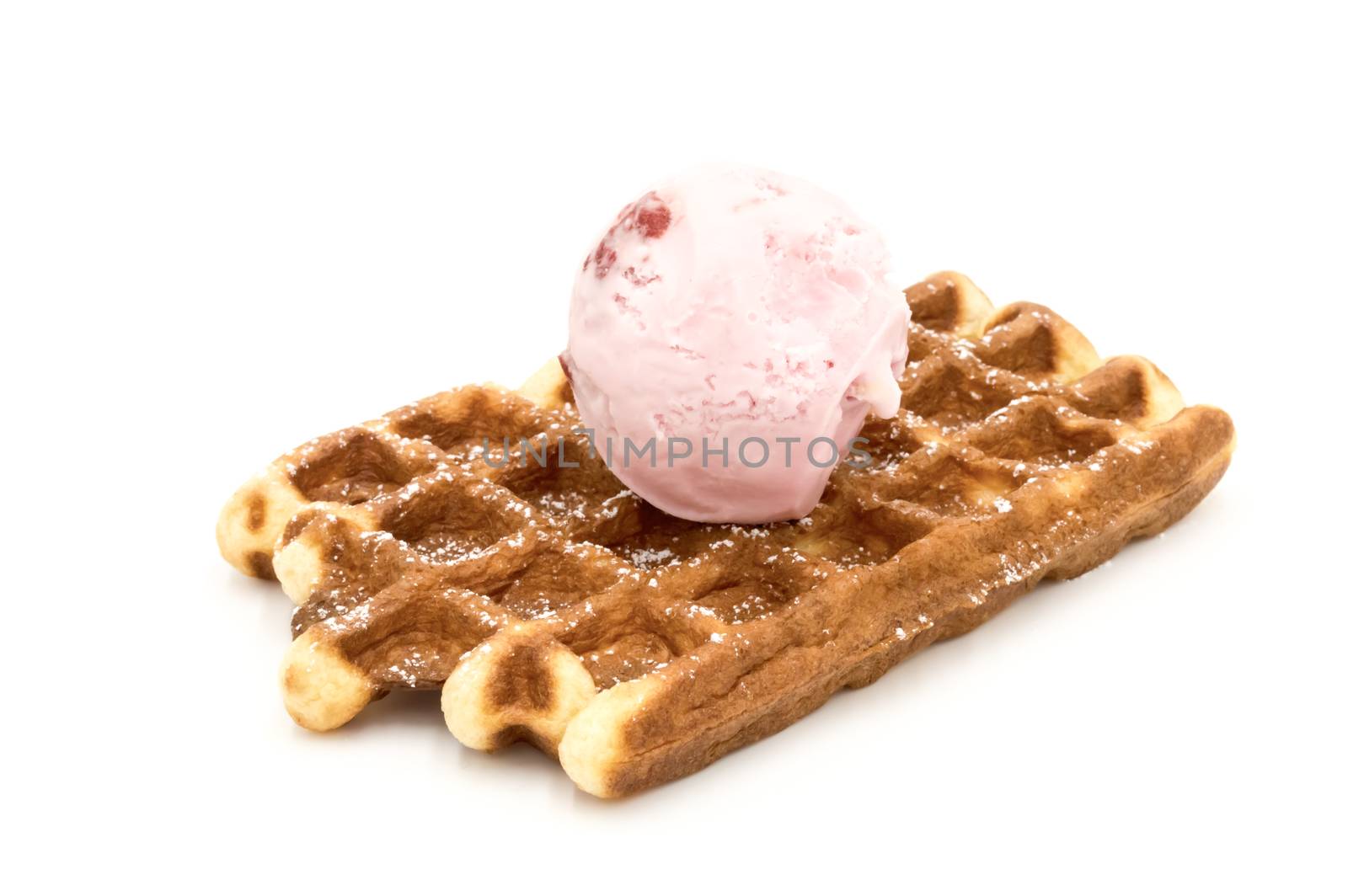 Freshly baked Belgian waffles with a scoop of strawberry ice cream