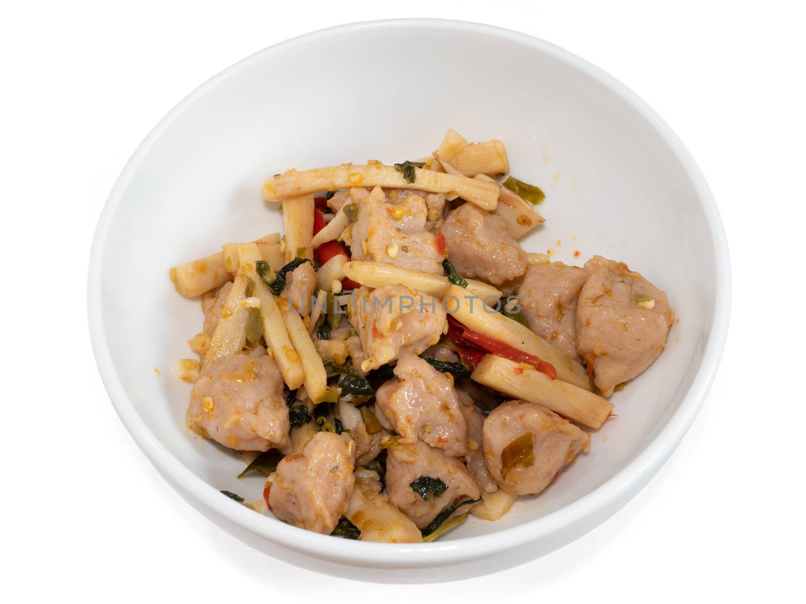 The close up of Fried Spicy Bamboo Shoot With fish ball (Thai food) in white bowl on white background.