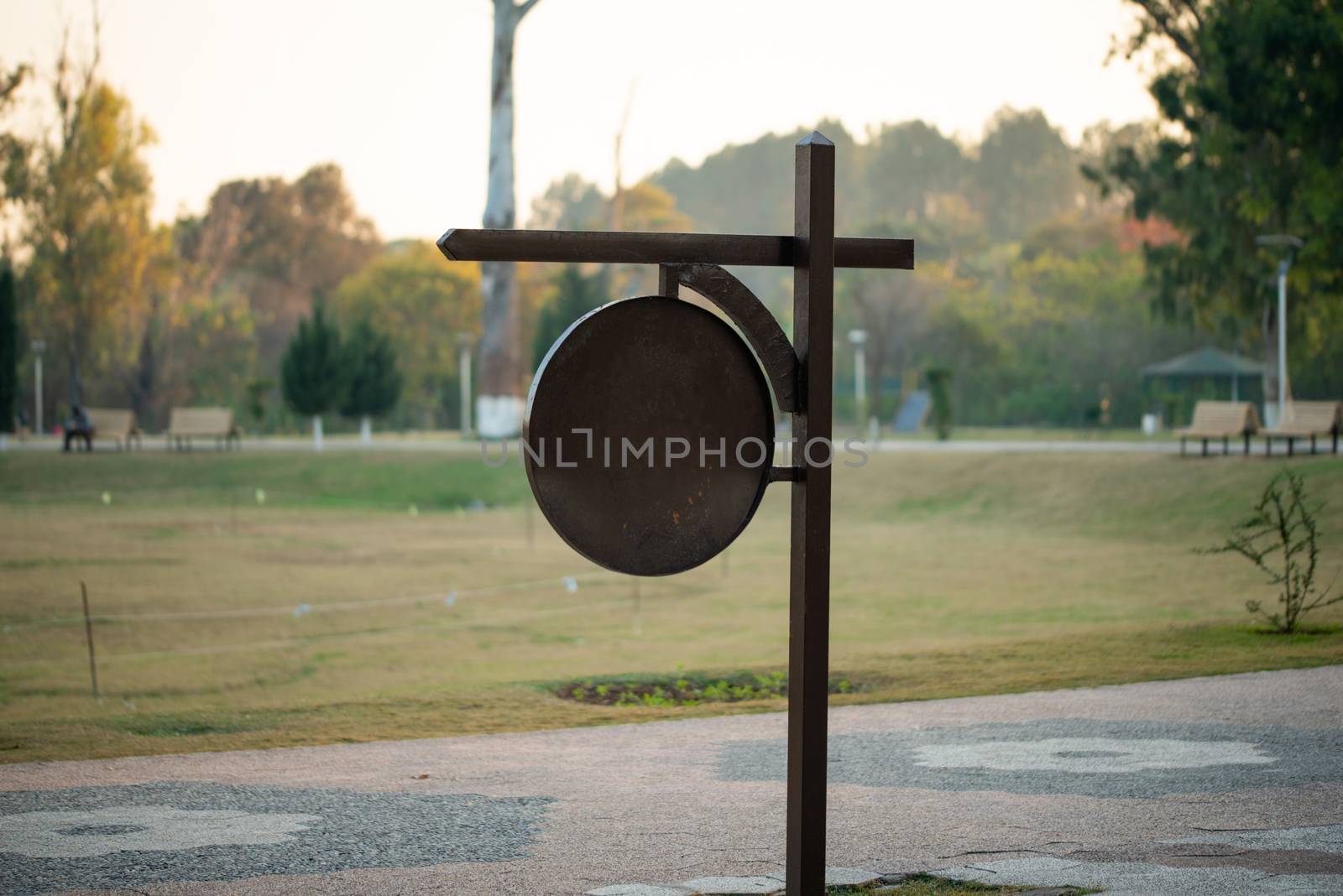 Blank Signboard on the pathway in garden by shaadjutt36