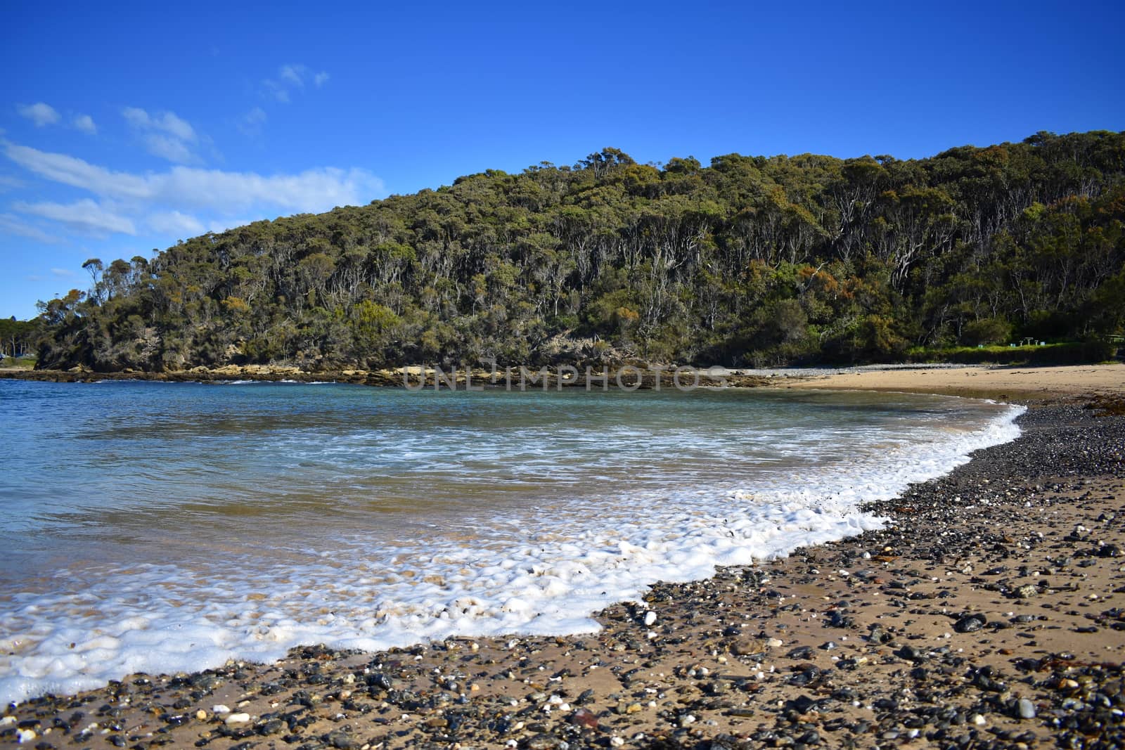 A beach with cliffs and mountains