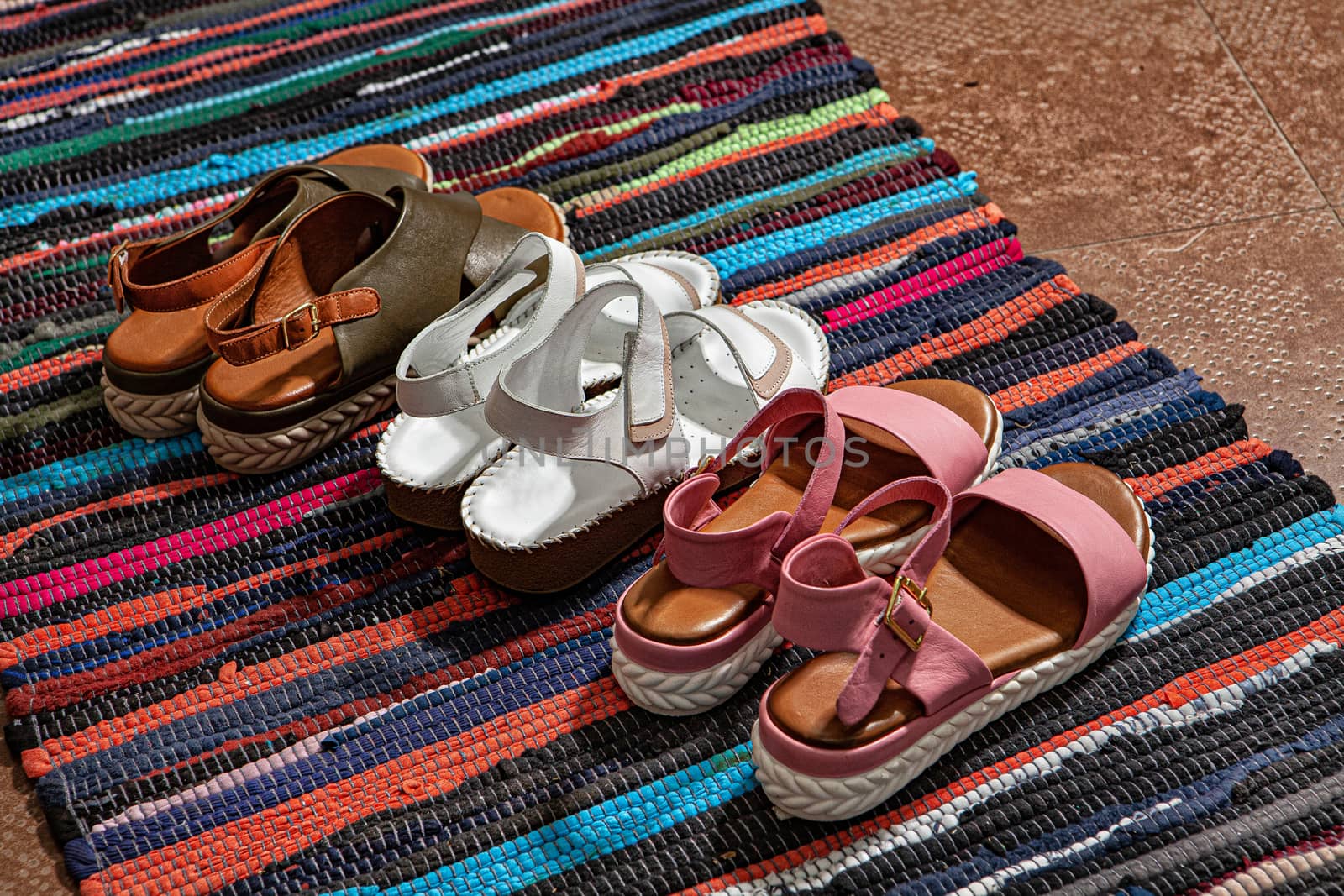 Different shoes with accessories on a studio background