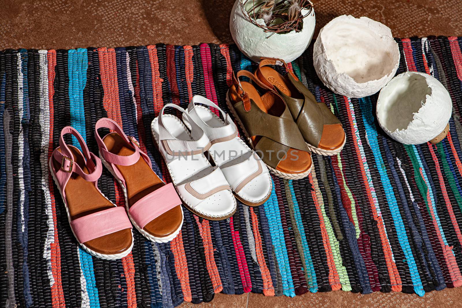 Different shoes with accessories on a studio background