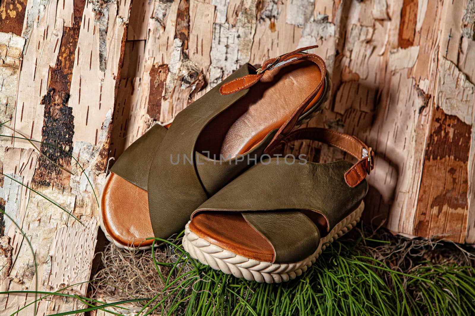 Different shoes with accessories on a studio background