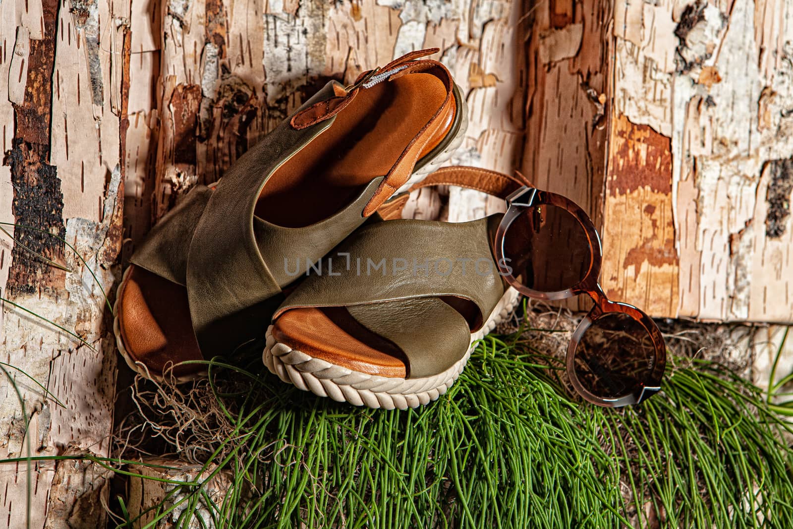 Different shoes with accessories on a studio background