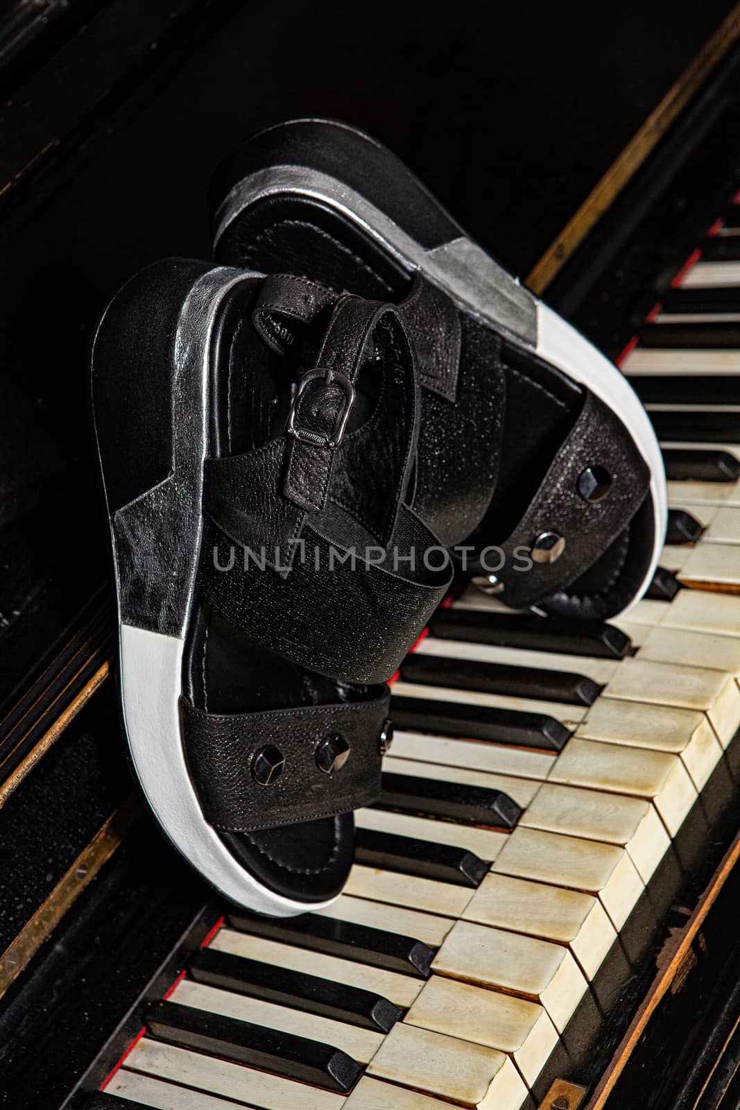 Different shoes with accessories on a studio background