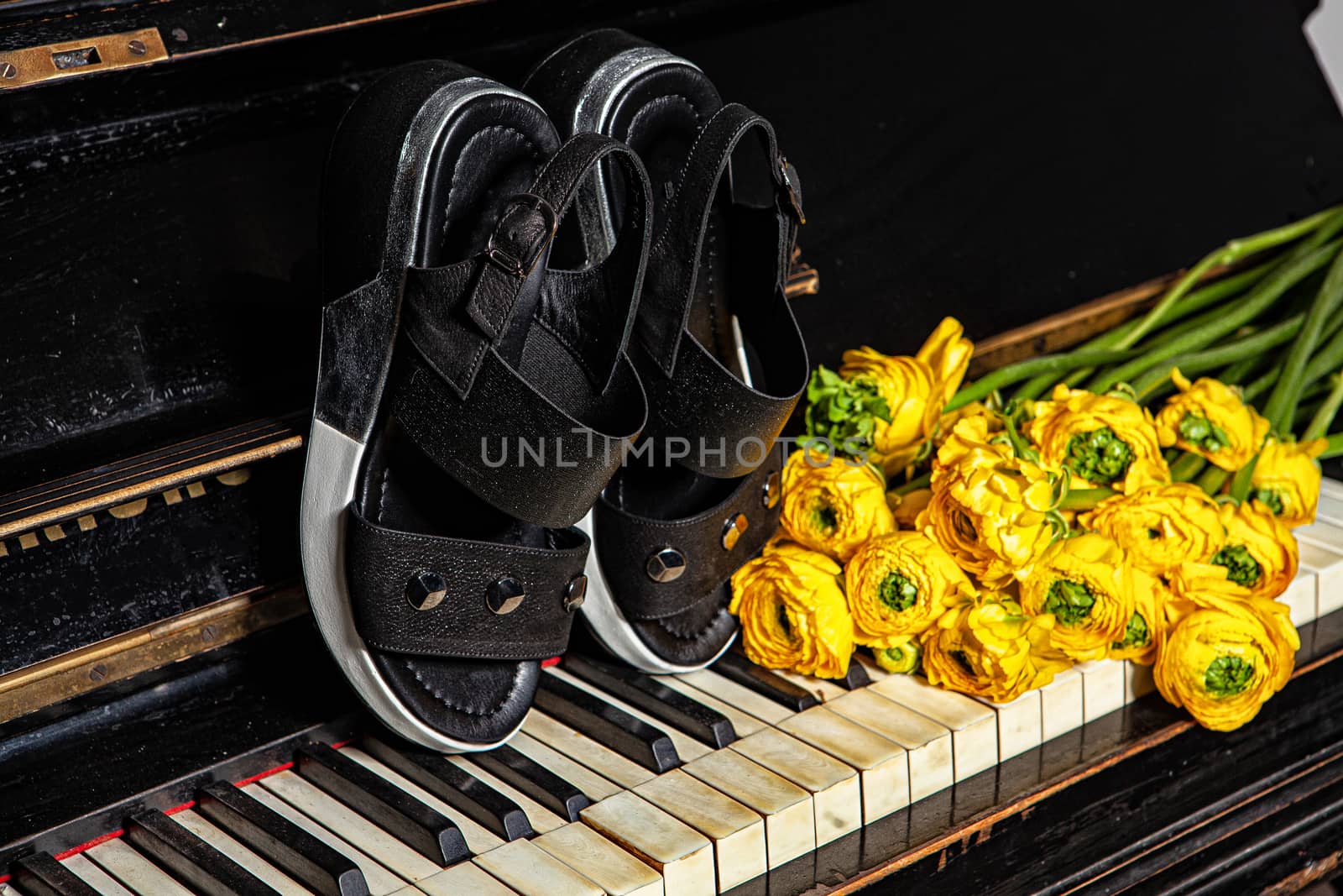 Different shoes with accessories on a studio background