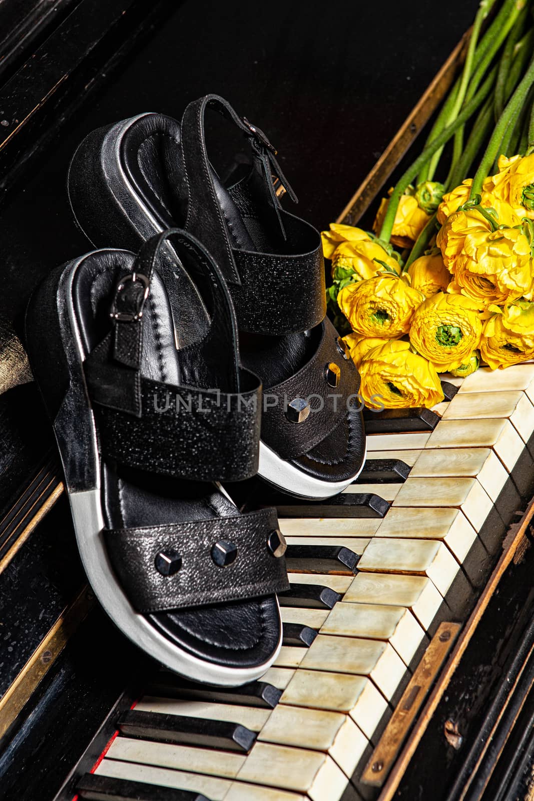 Different shoes with accessories on a studio background
