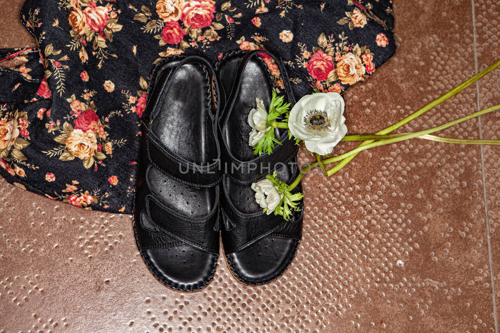 Different shoes with accessories on a studio background