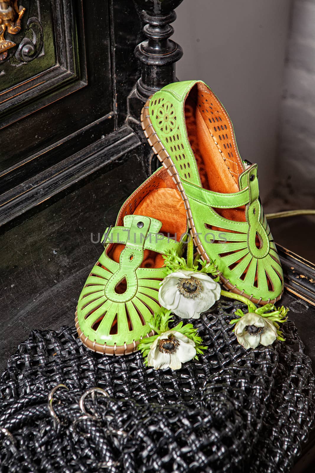 Different shoes with accessories on a studio background
