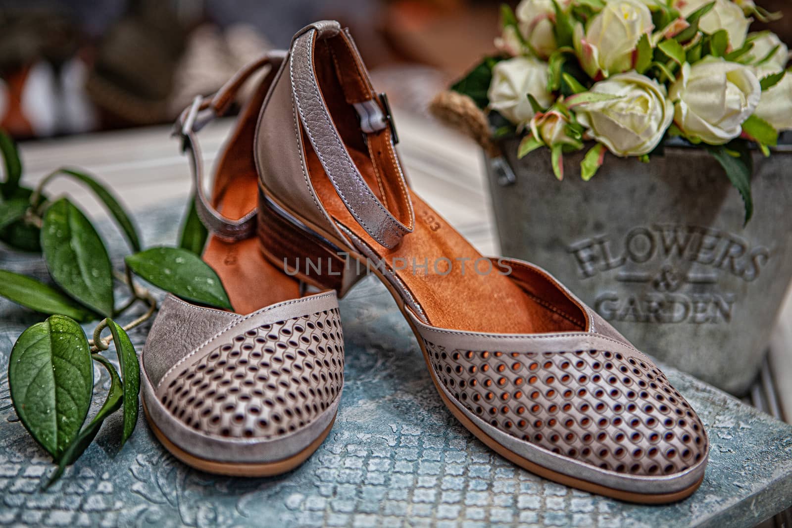 Different shoes with accessories on a studio background