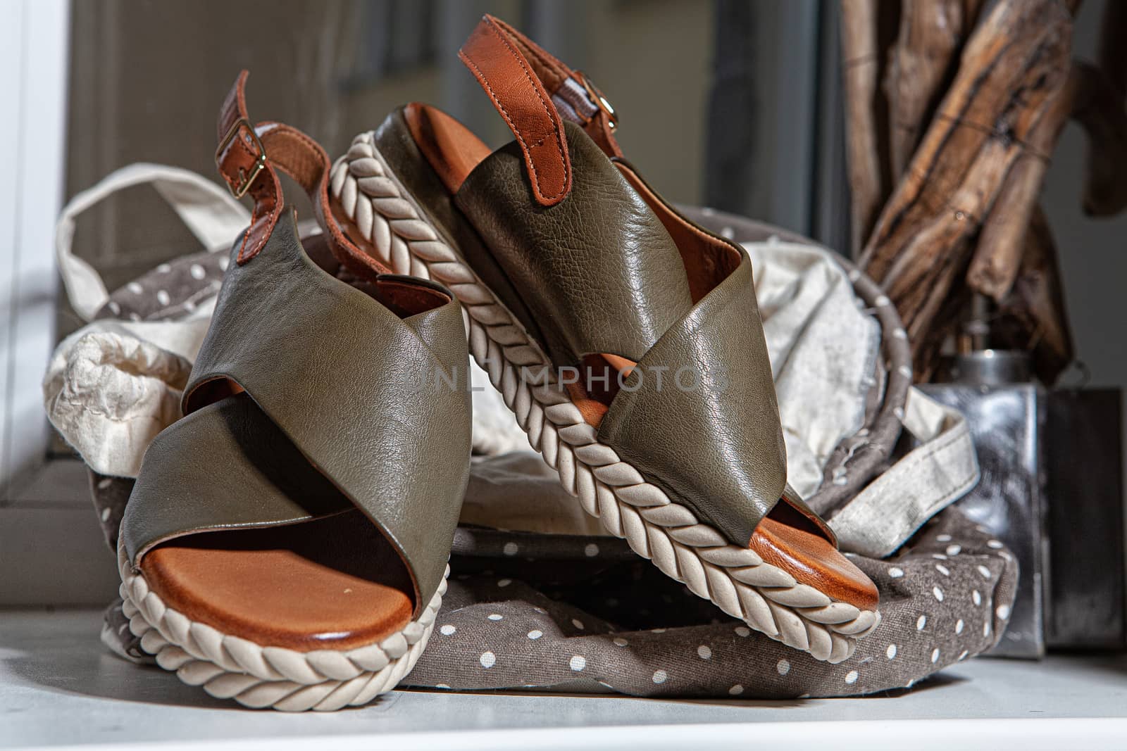 Different shoes with accessories on a studio background