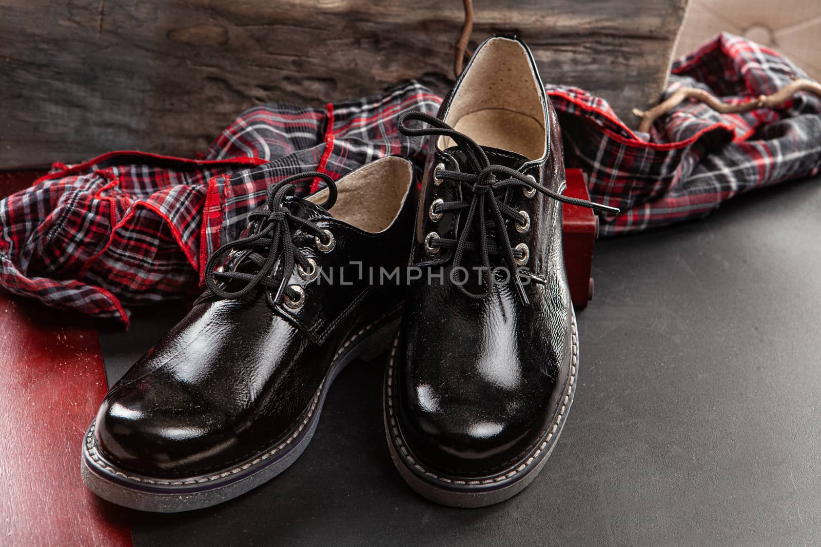 Woman's legs and shoes on a wooden background