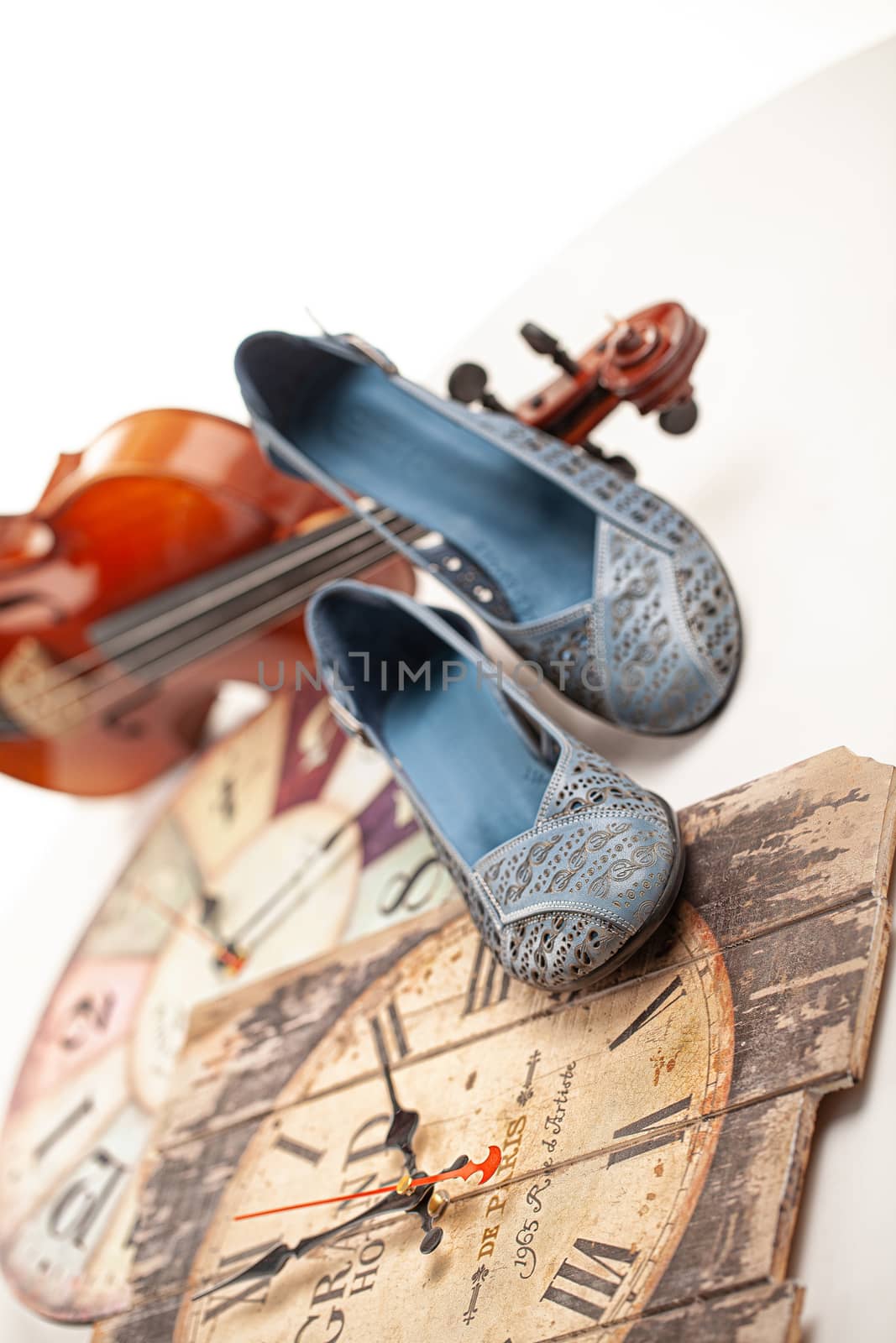 Different shoes with accessories on a studio background