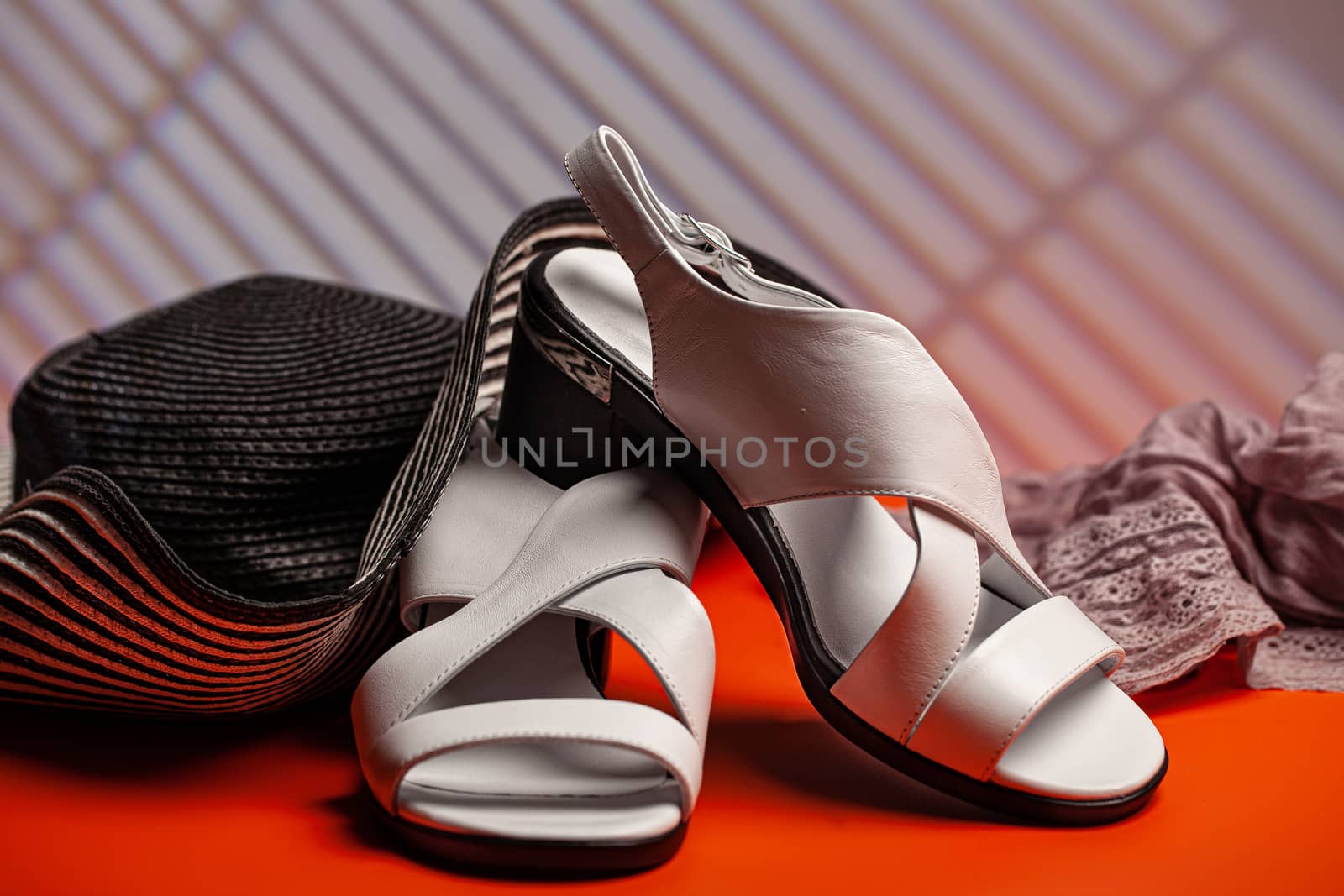 Woman's shoes and accessories on a studio background