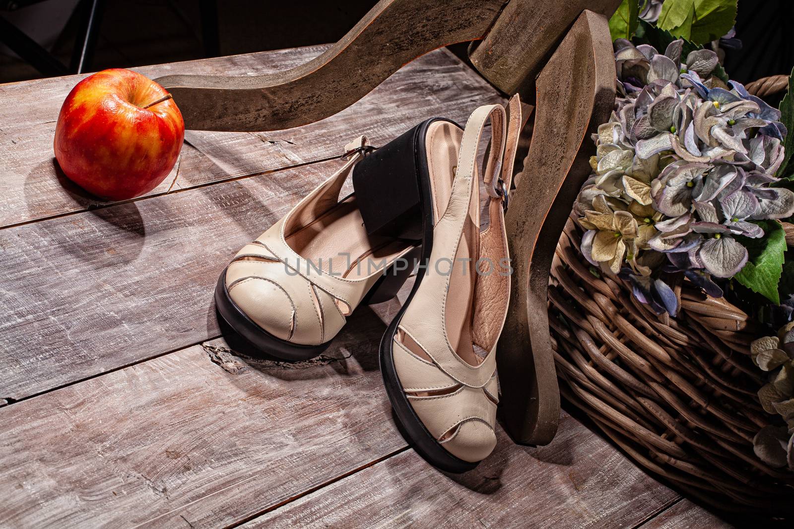 Woman's shoes and accessories on a studio background