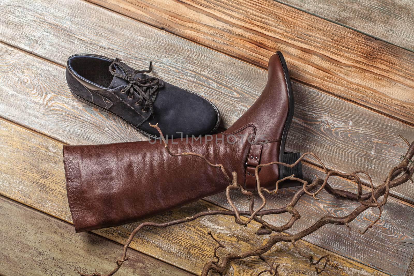 Different kinds of shoes on a wooden desk