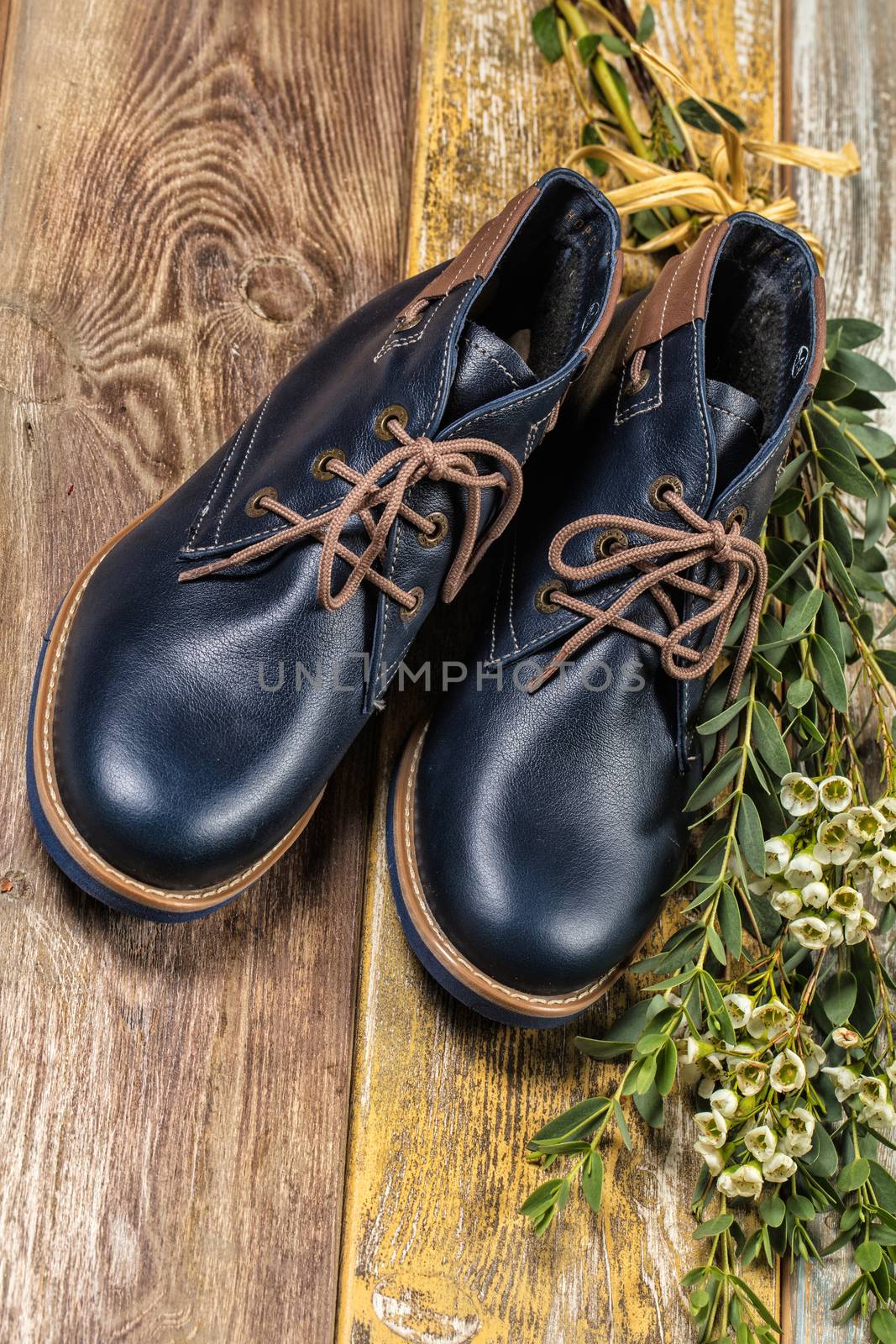Different kinds of shoes on a wooden desk