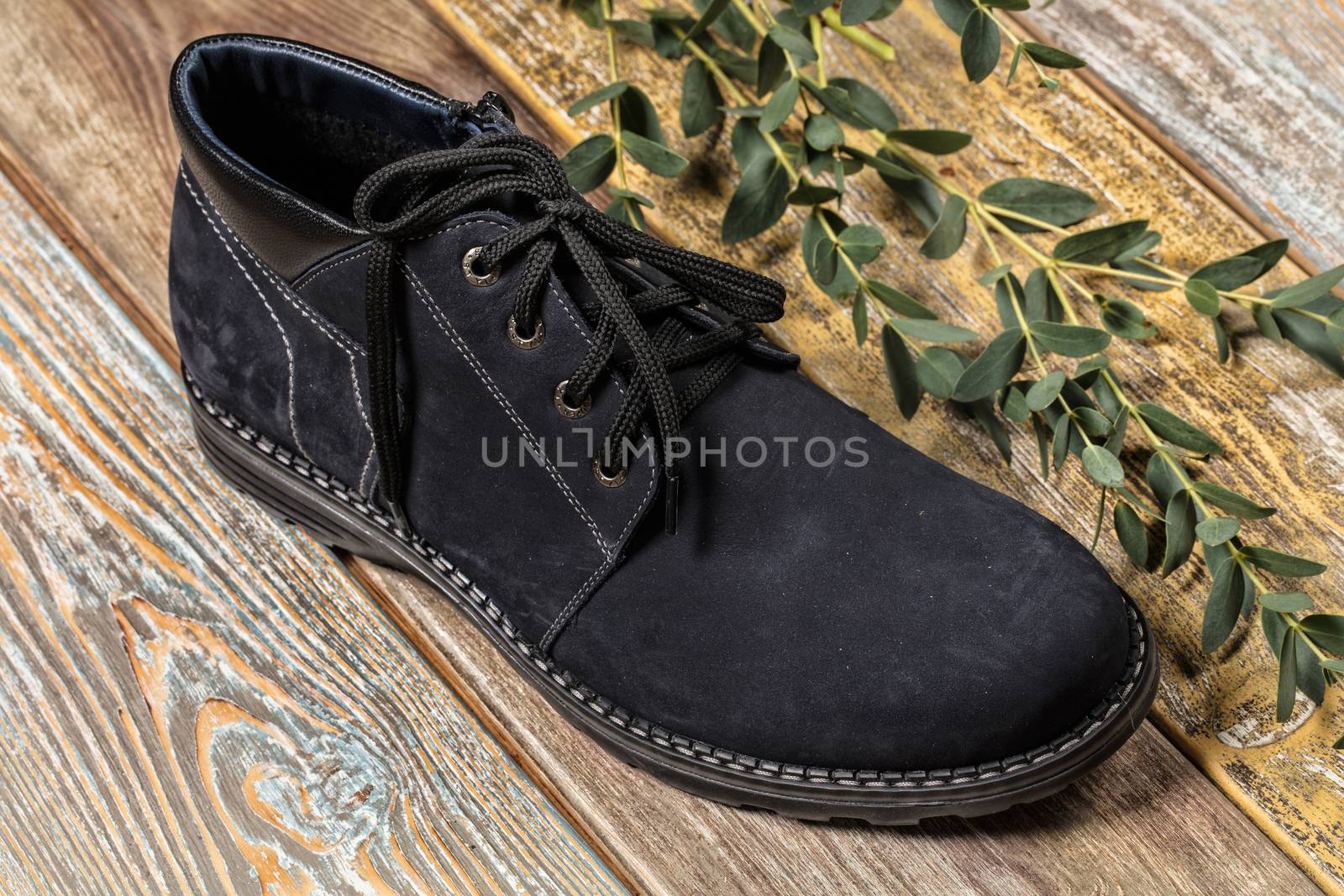 Different kinds of shoes on a wooden desk