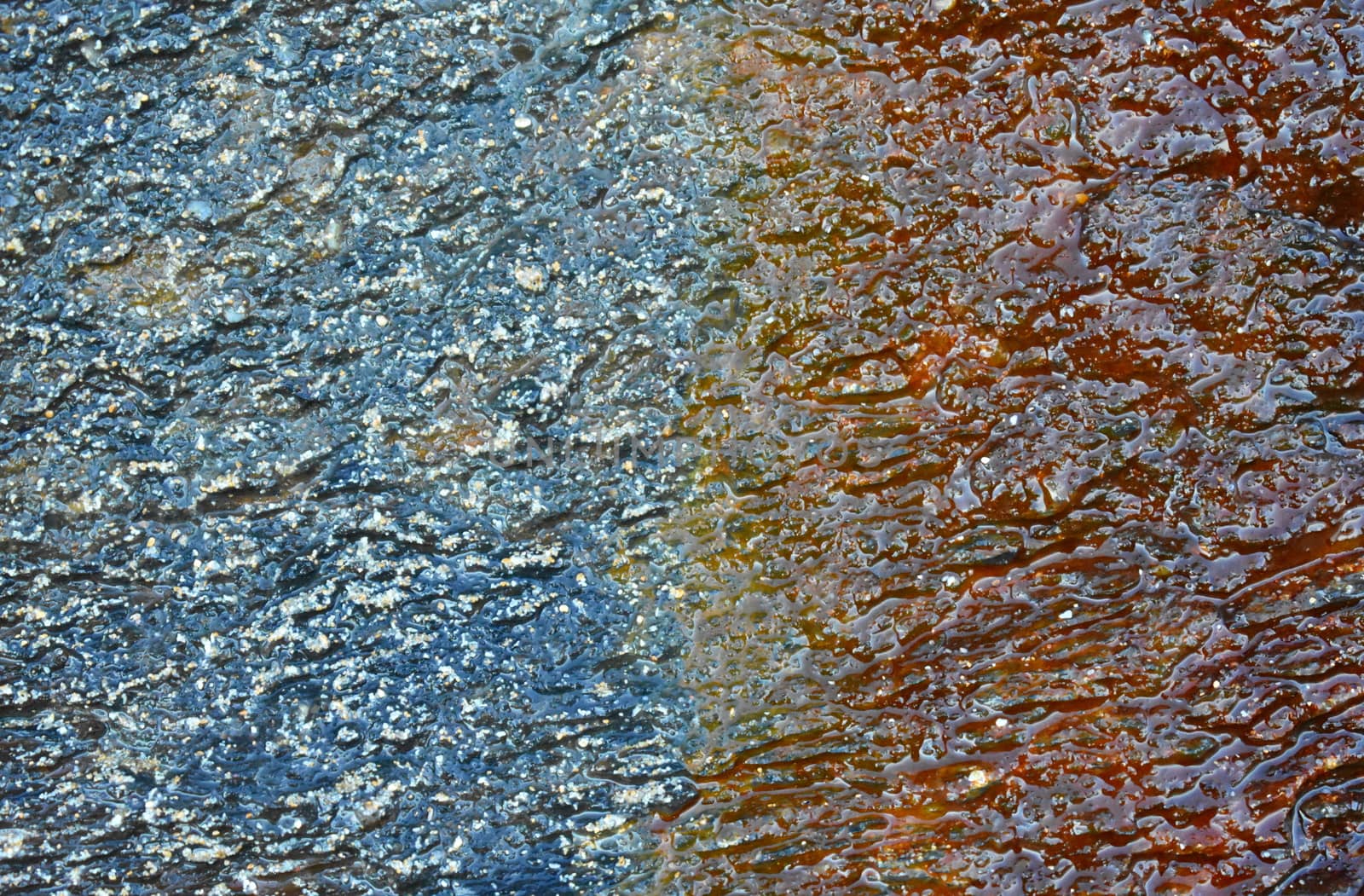 A close up of a rock with a coloured pattern on it