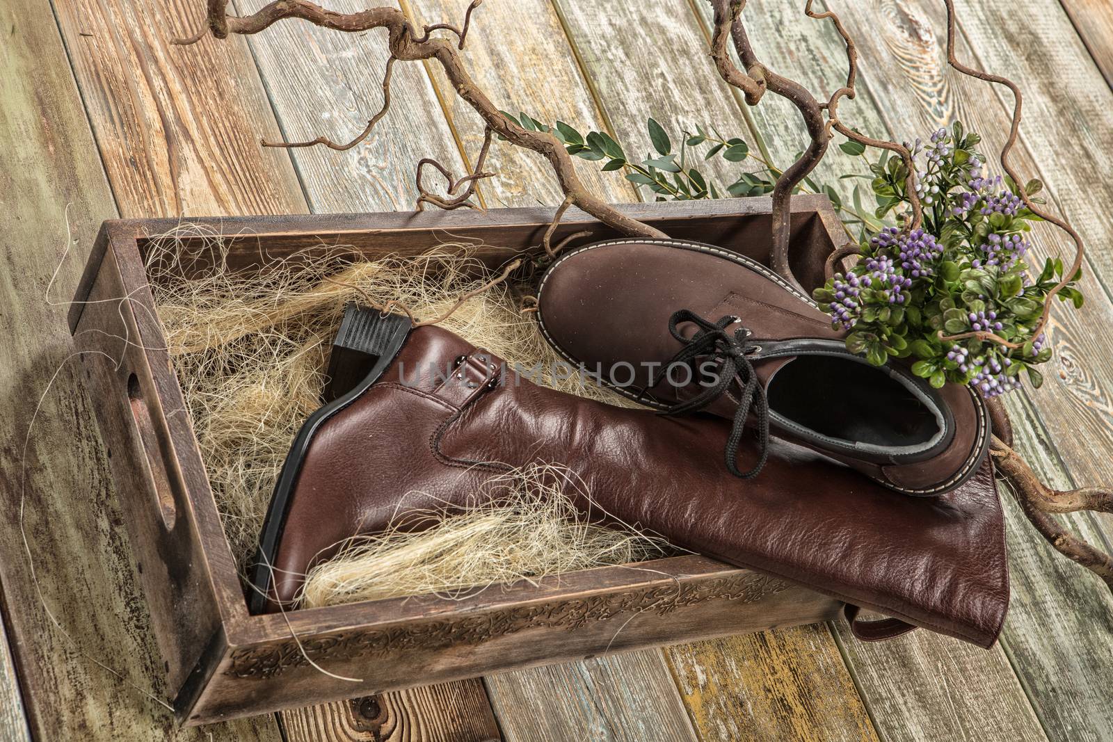 Different kinds of shoes on a wooden desk