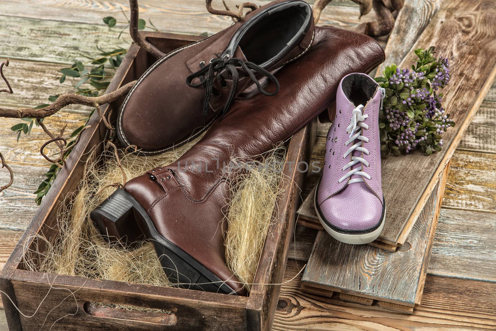 Different kinds of shoes on a wooden desk