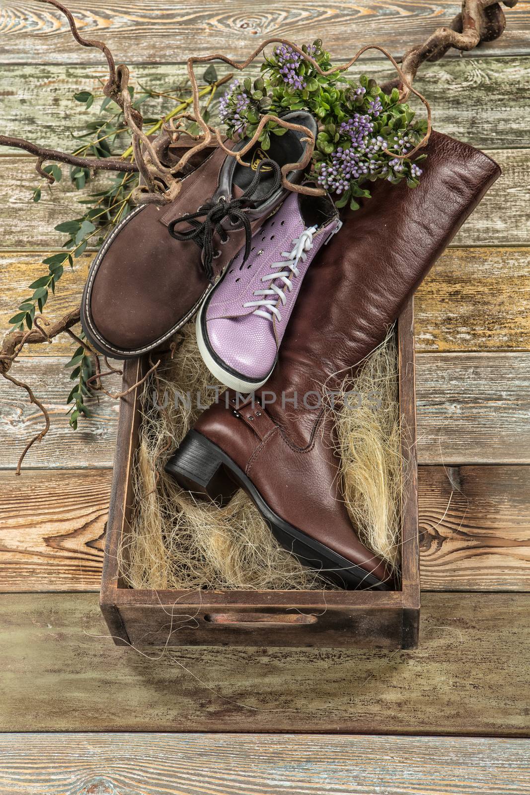Different kinds of shoes on a wooden desk