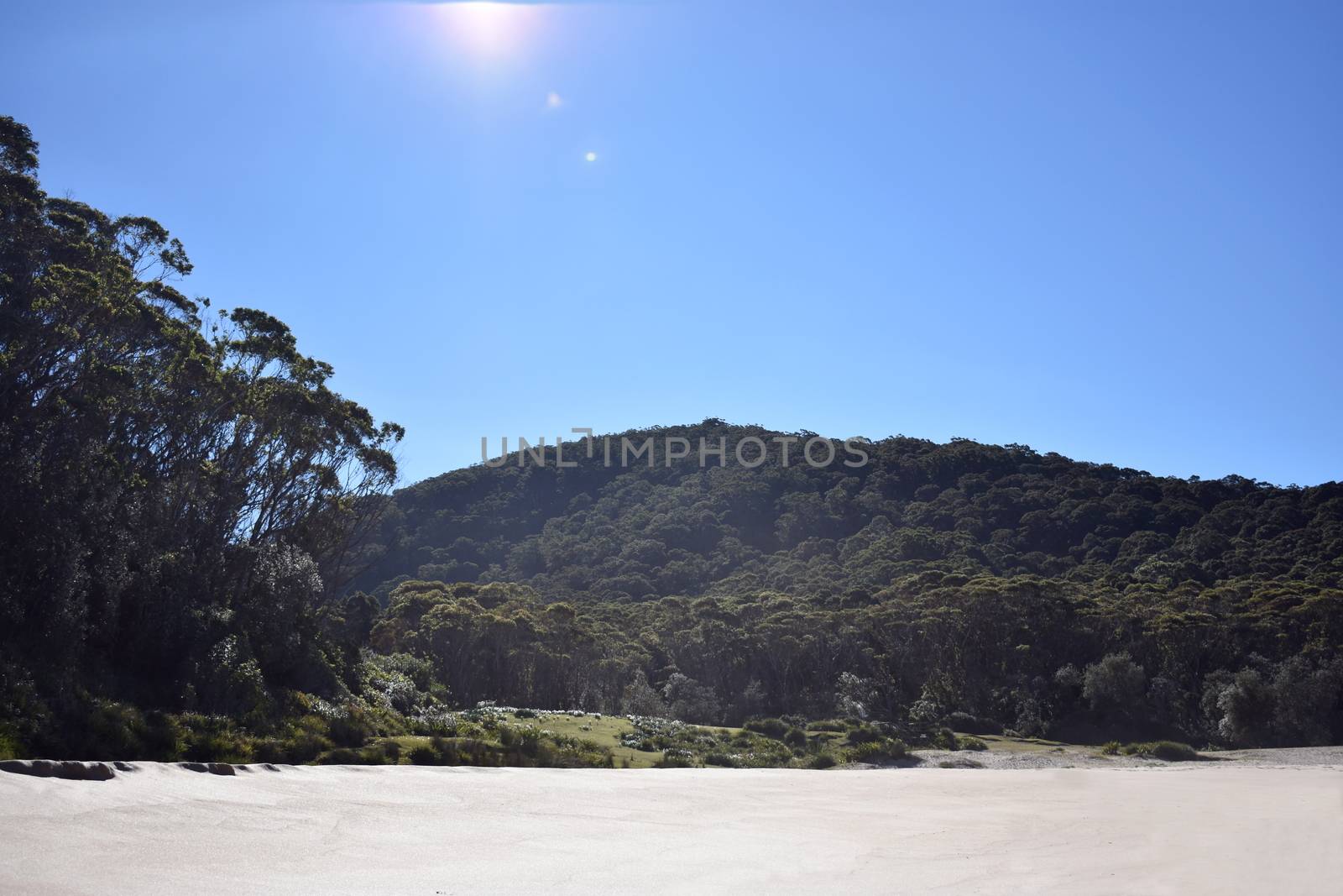 Beach view with sand and mountains