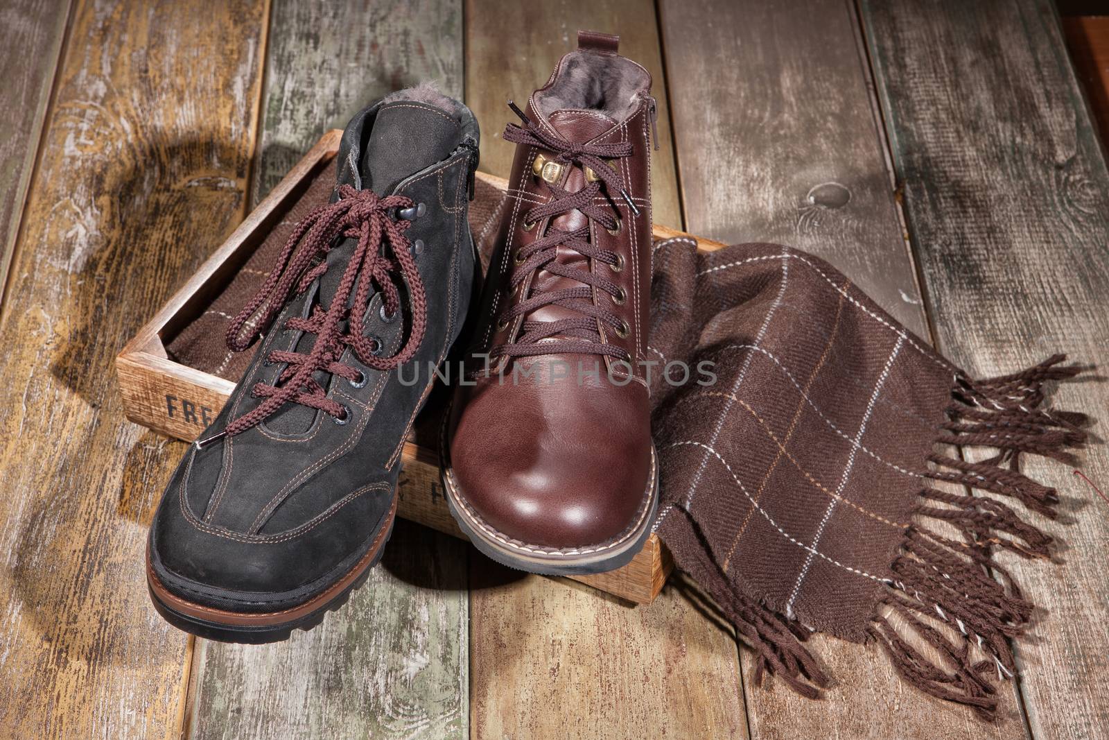 Different kinds of shoes on a wooden desk