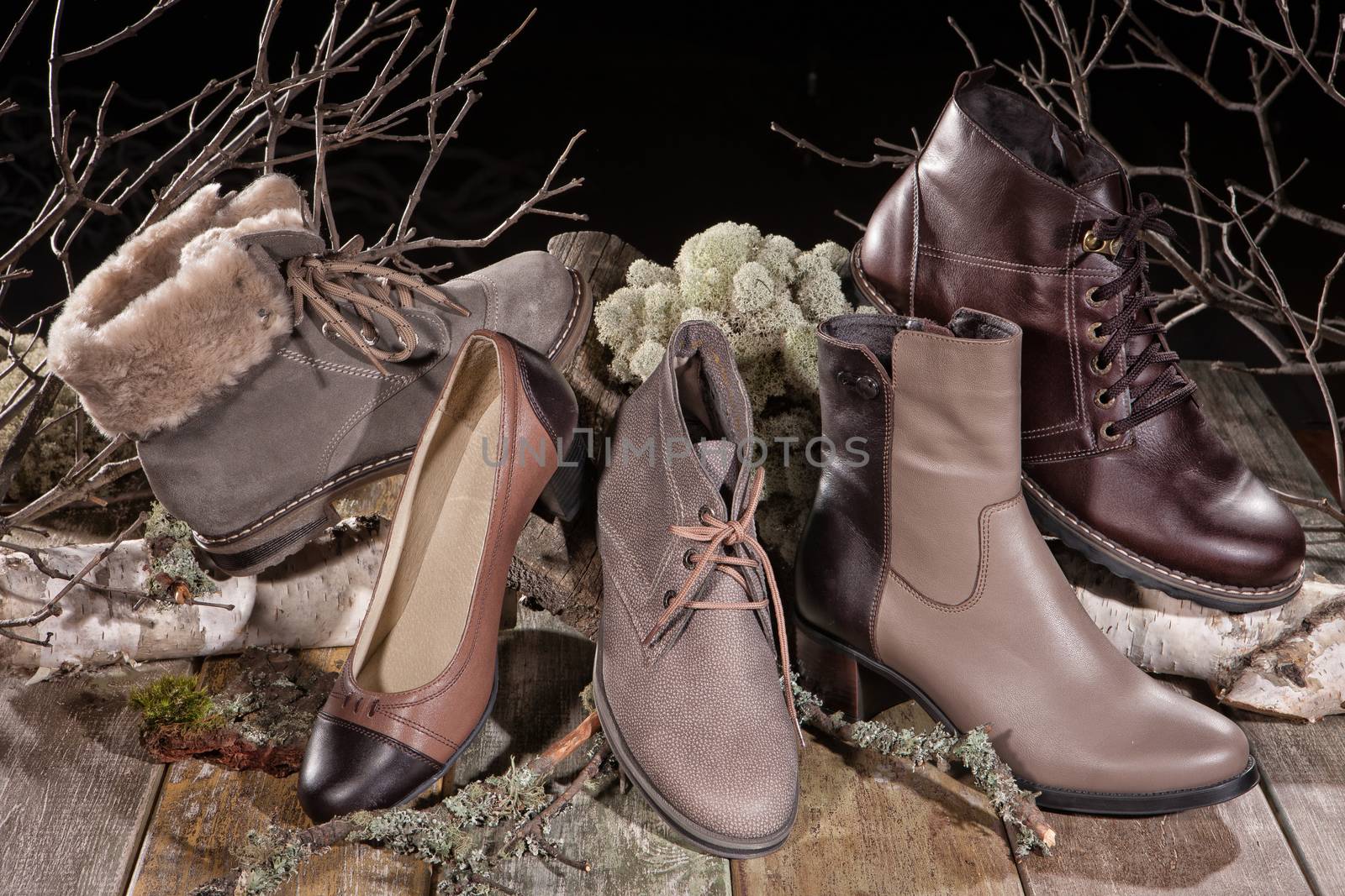 Different kinds of shoes on a wooden desk