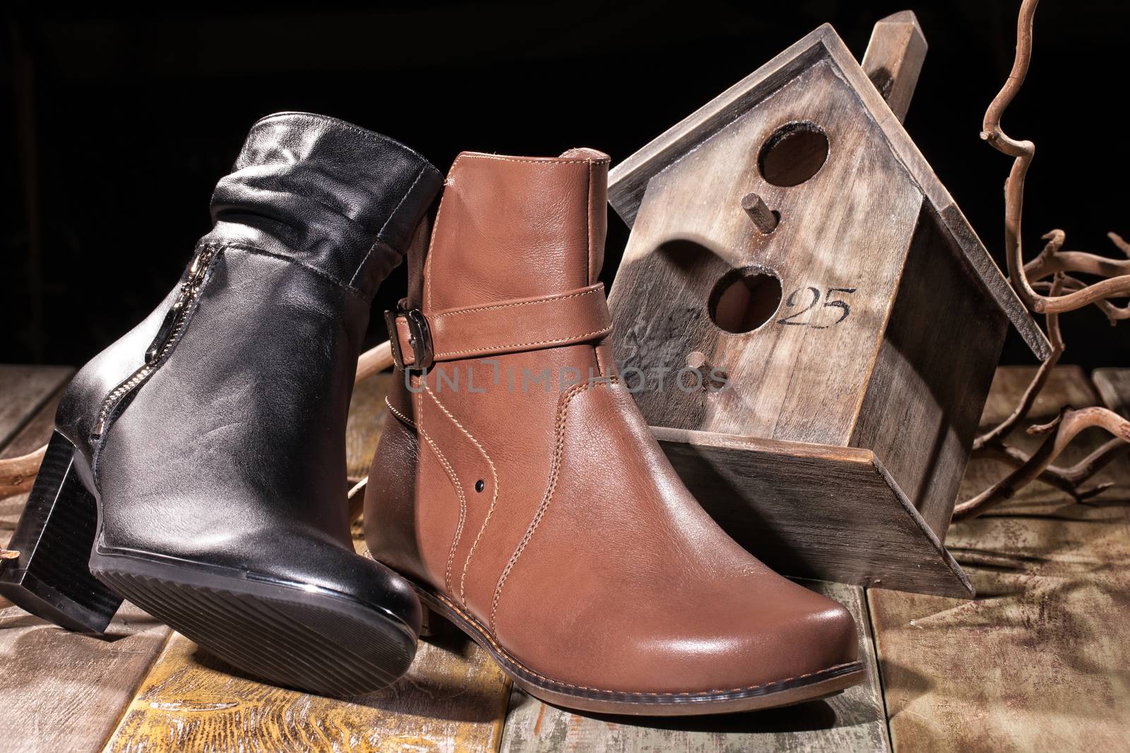 Different kinds of shoes on a wooden desk