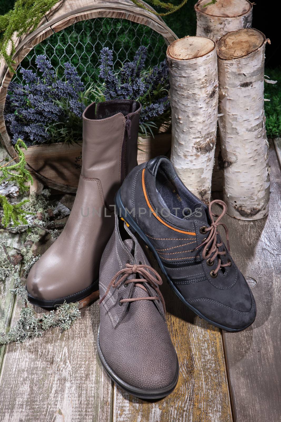 Different kinds of shoes on a wooden desk