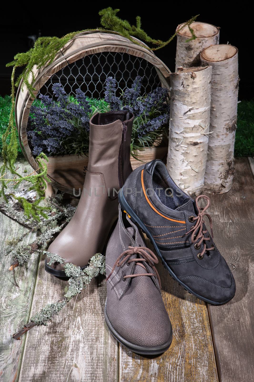 Different kinds of shoes on a wooden desk