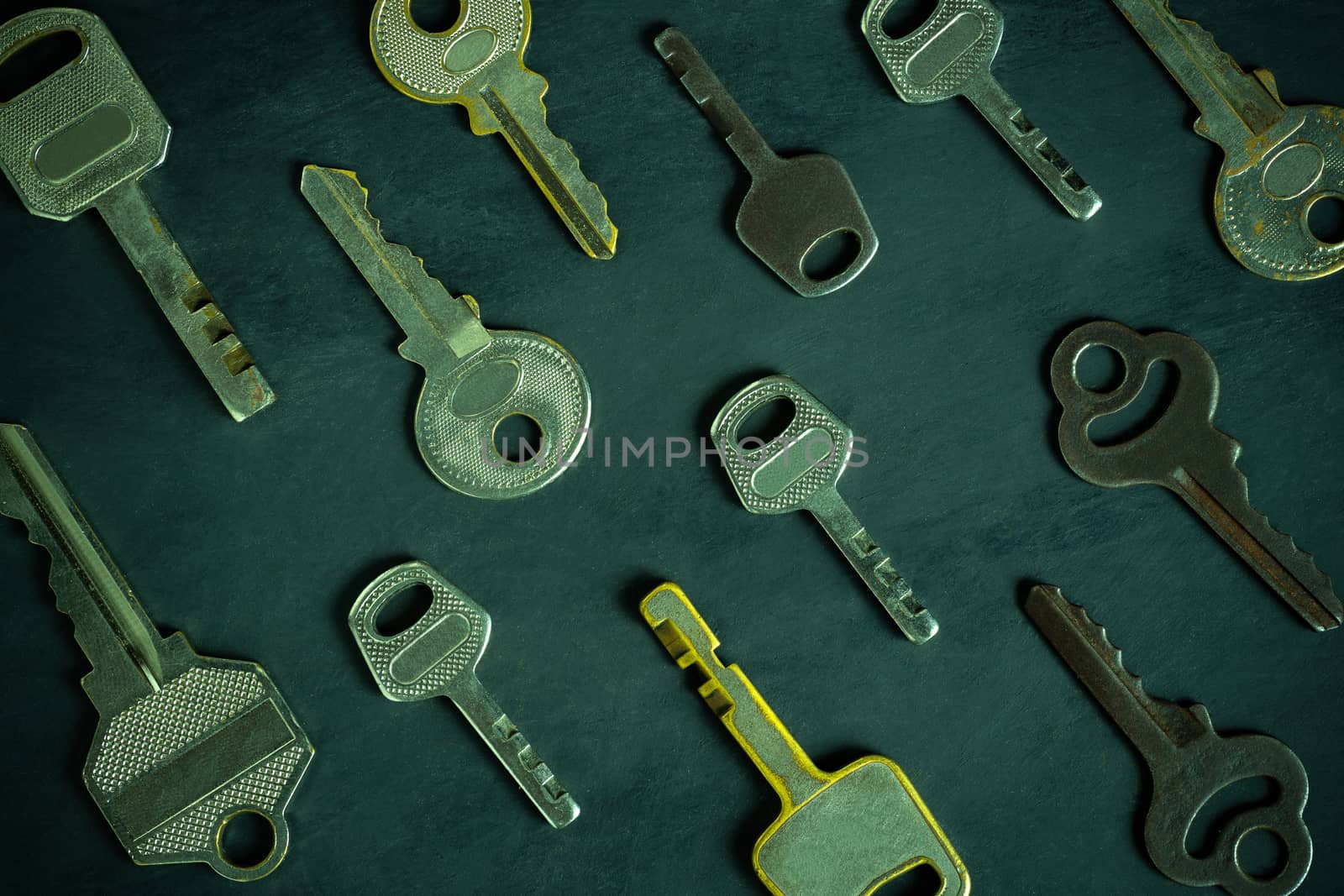 Close up much different variety of vintage keys orderly on black wooden table in darkness background. The idea for the key to solving business problems to success. Concept for security or privacy.