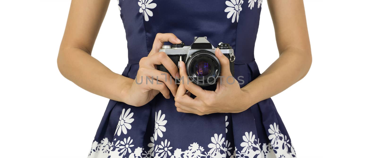 Young traveler in blue dress holds the old camera by hand in the hip position. by chadchai_k