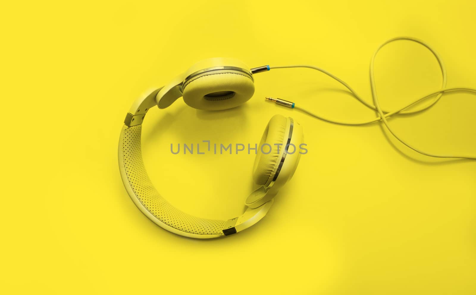 Top view yellow headphones and Convention Aux cable 3.5 mm by SlayCer