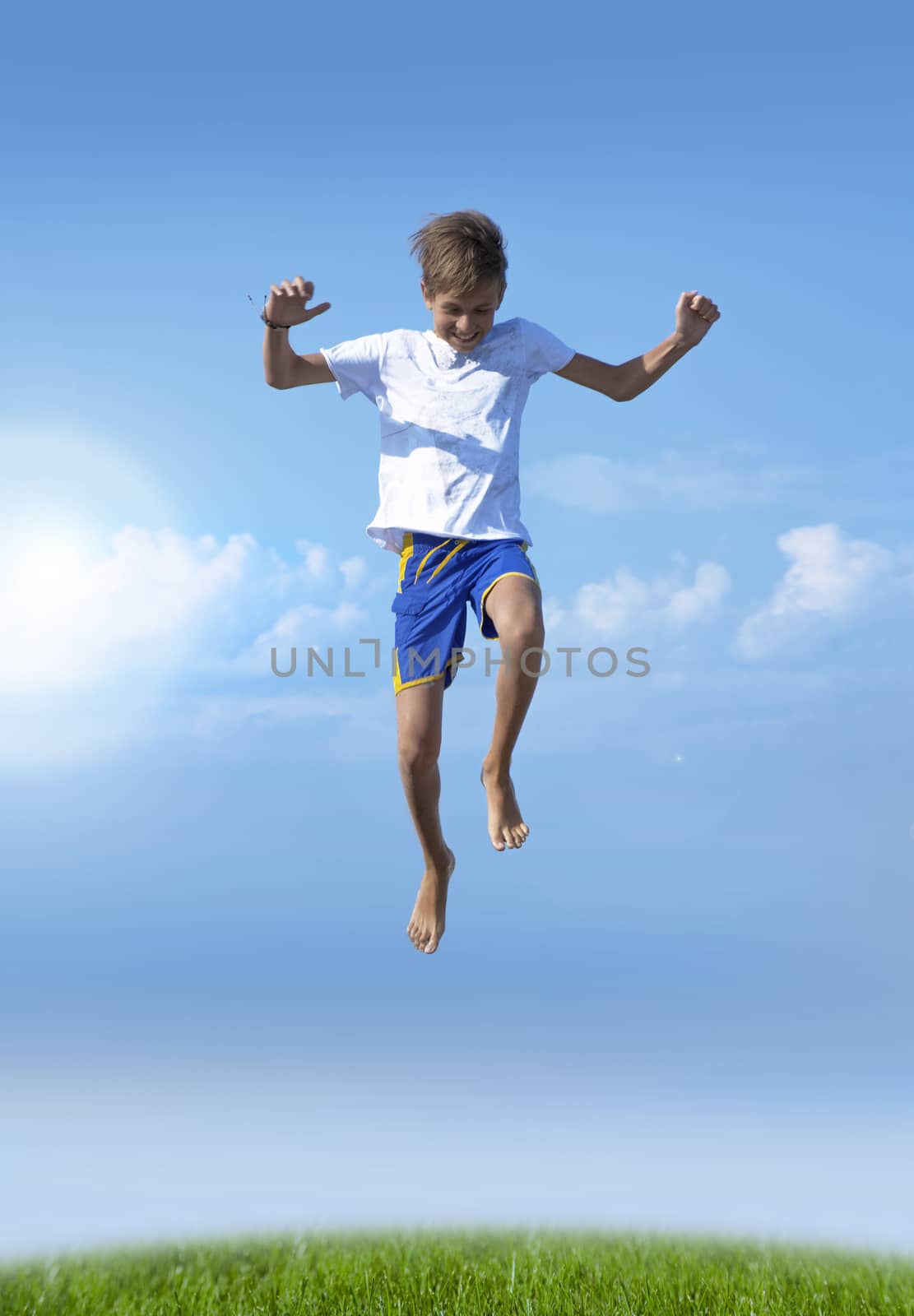 A boy jumps on a summer background of blue sky by SlayCer