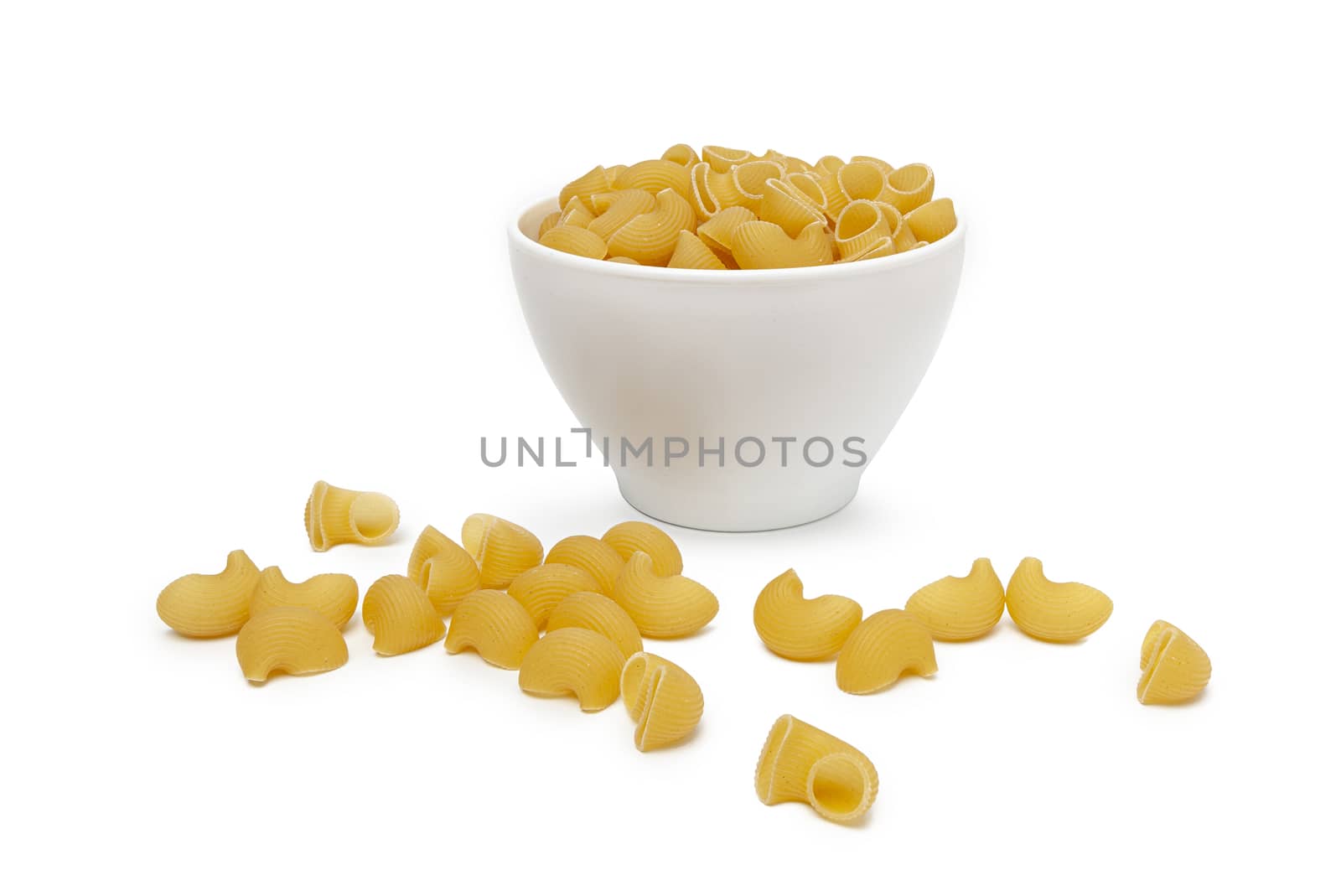 Pasta Pipe Rigate in a white bowl. Isolated on a white background